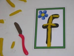 Using play dough to make laphabet letters