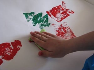 Pressing paint covered sponges onto paper