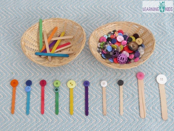 Invitation to play with buttons and pop sticks