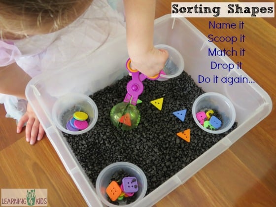 Sorting shapes activity using a sensory bin and scooper scissors by learning 4 kids