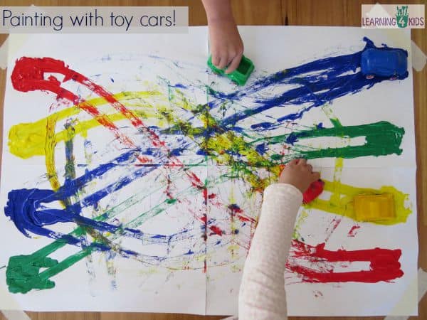 Painting with toy cars and learning colours.