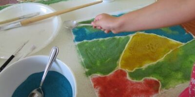 Exploring colours using sand - creative art inspired by Magic Beach by Alison Lester