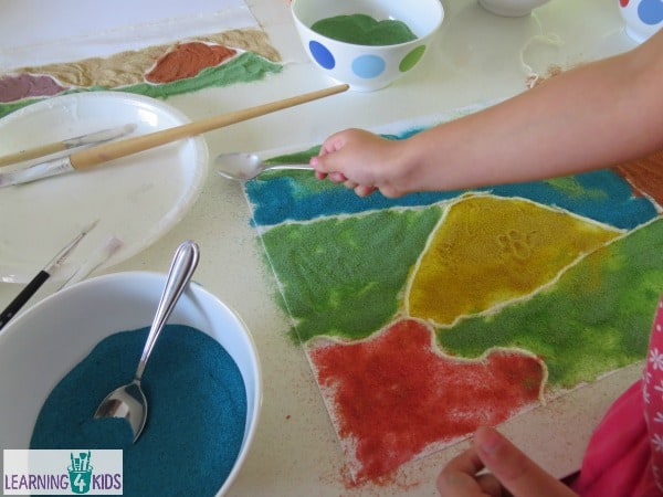 Exploring colours using sand - creative art inspired by Magic Beach by Alison Lester