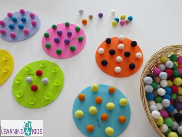 making patterns with felt balls - fine motor activity balancing felt balls